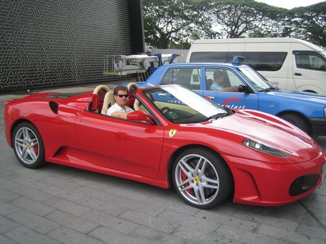 Driving a red Ferrari convertible